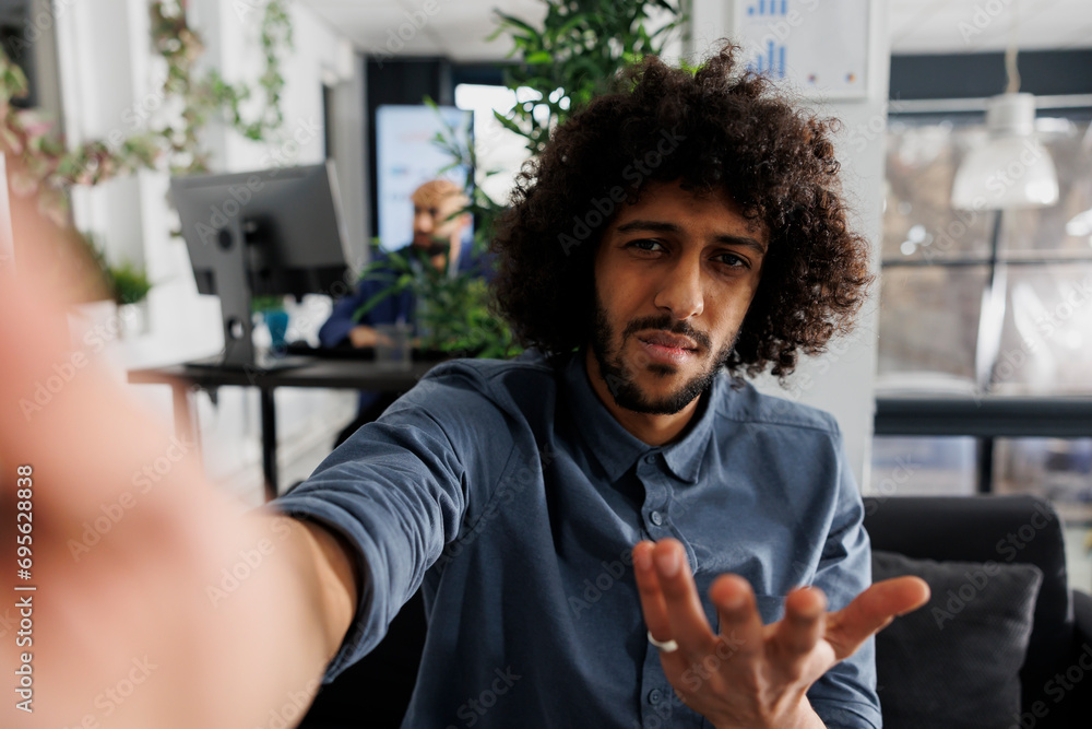 Poster confused start up company product manager discussing project with client on smartphone videocall and
