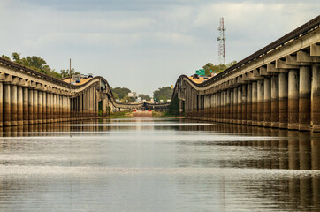 Receding pillars of the I-10 interstate bridges over the bayou of Atchafalaya basin near Baton...