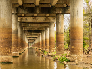 Receding pillars of the I-10 interstate bridge over the bayou of Atchafalaya basin near Baton Rouge...