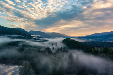 Valley by Lake, Mountains and Green Trees covered in fog. Canadian Landscape Nature Aerial...