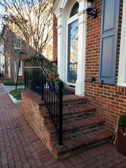 Brick steps leading to the front door with Christmas decorations.