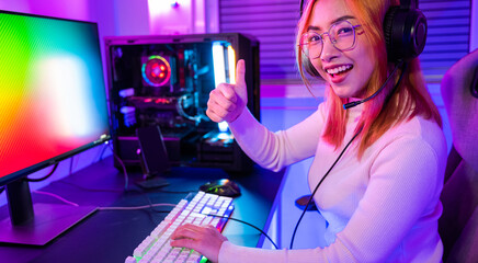 Smiling woman live stream she play video game at home neon lights living room, Gamer playing online...