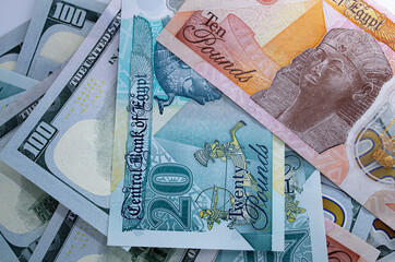 Close-up view of one hundred dollar bills and new Egyptian banknotes currency exchange concept 