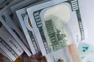 Close-up view of one hundred dollar bills and new Egyptian banknotes currency exchange concept 