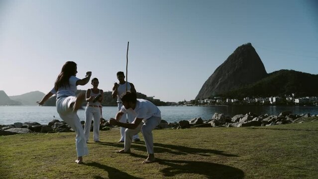 Group of people playing capoeira, an Afro-Brazilian martial art, in Rio de Janeiro. Cinematic 4k.
