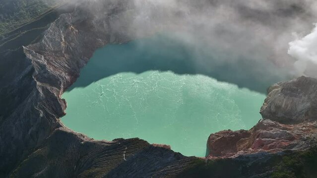 Aerial view drone orbit around to reveal Kawah Ijen volcano crater, Indonesia
