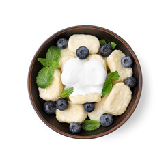 Bowl of tasty lazy dumplings with blueberries, mint leaves and sour cream isolated on white, top...