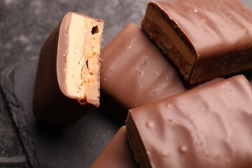 Tasty chocolate bars with nougat on gray table, closeup
