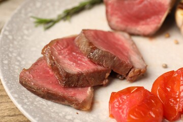 Delicious grilled beef steak with tomatoes on plate, closeup