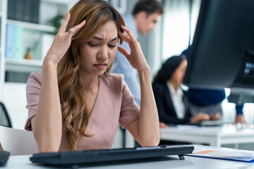 Exhausted Asian young businesswoman overwork late in office workplace. 