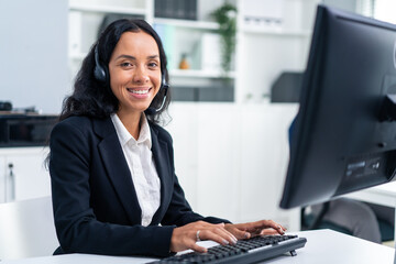Portrait of Latino beautiful business woman smile while work in office.