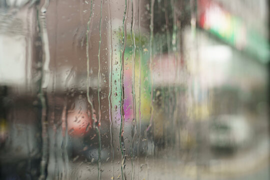Wet window on the background of city street 