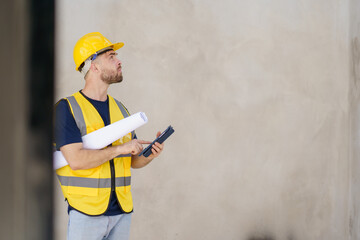 Senior professional caucasian white male real estate foreman inspecting inside the building construction, foreman checking the under construction building. Caucasian male engineer inspects interior.