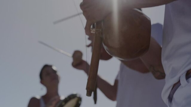 Young people playing typical Brazilian musical instruments in Rio de Janeiro. Cinematic 4k.