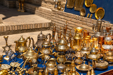 Fototapeta na wymiar Copper teapots and cups in the Old Town of Bukhara, Uzbekistan
