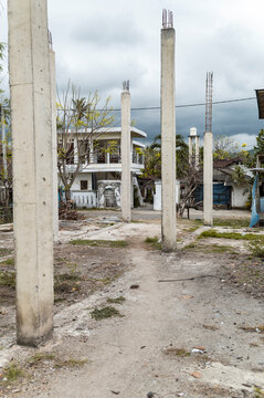 Abandoned construction building, unfinished concrete pilars and structure under a cloudy sky, Indonesia, Asia	
