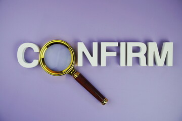 Confirm alphabet letters with magnifying glass, business and education concept background