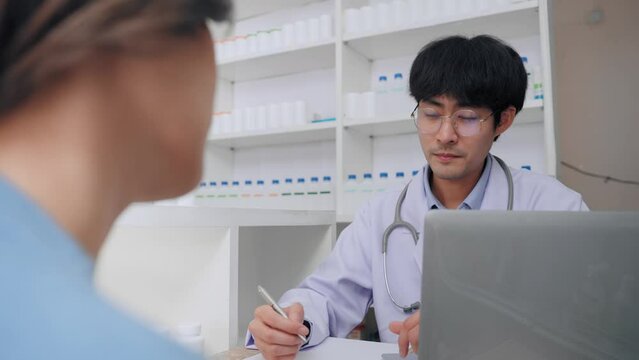 Asian female patient have symptoms toothache to consulting doctor at clinic. Asian customer woman want to buying medicine gum inflammation relief with pharmacist man at pharmacy shop.