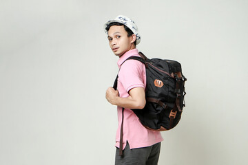 attractive asian man backpacker back pose portrait. travelling concept. on isolated background