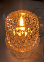 burning candle in the glass that transmits peace and calm, yellow