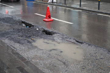Big pot hole filled with water at street