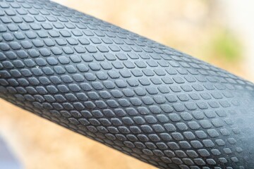 Rubber textured and factured surface in view of scooter handles.