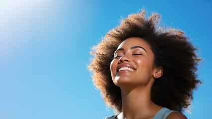 A African woman breathes calmly looking up isolated on clear blue sky