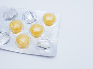 Yellow pills in blister pack isolated on white background with copy space.