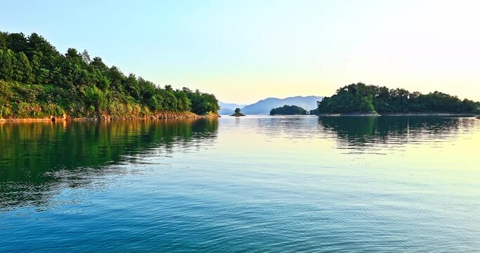 Clear lake and green forest with mountain in the summer, Hangzhou, China. Beautiful Xin 'anjiang reservoir natural landscape.