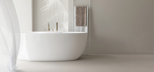 White freestanding ceramic bathtub, towel rack ladder, blowing cheer curtain in sunlight, shadow on...