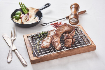 Oily and delicious pork barbecue on a small grill