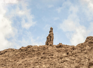 Lots  Wife is a rock salt column on the shores of the Dead Sea in Jordan. Resembles the shape of a woman. Traditionally perceived as the petrified wife of the biblical righteous man Lot