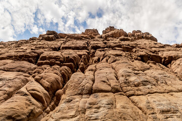 High  mountains at the beginning of the tourist route in the Mujib River Canyon in Wadi Al Mujib in Jordan