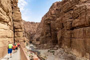 Tourists begin to follow the tourist in the Mujib River Canyon in Wadi al Mujib in Jordan