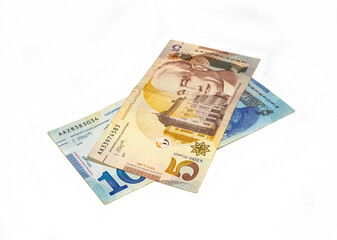 Two  banknotes of the National Bank of Georgia in denominations of five and ten Lari on a white...