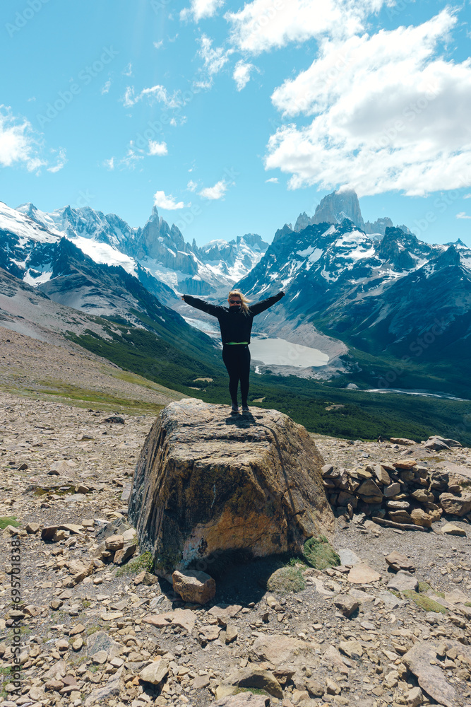 Wall mural woman poses in beautiful view towards cerro torre