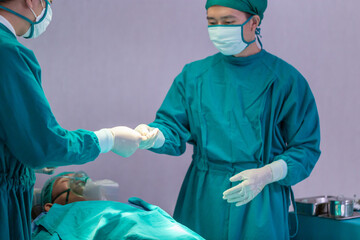 Medical team performing surgical operation in operating Room, Concentrated surgical team operating...