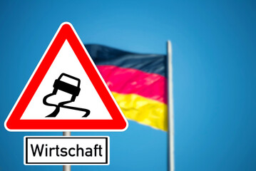 Deutsche Flagge und Verkehrsschild Wirtschaft ins Schleudern geraten