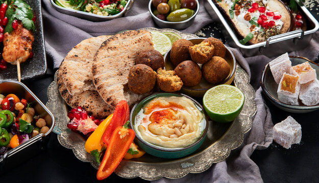 Middle eastern or Arabic different dishes on black background. Tasty traditional food concept