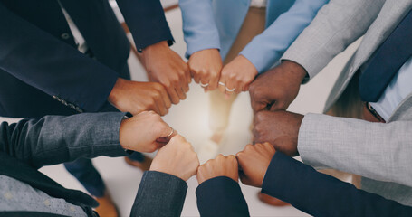 Business people, teamwork and fist of hands in circle for collaboration, synergy and motivation of global equality from above. Closeup, corporate group and cooperation for support, inclusion or trust