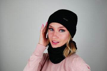 Blue-Eyed Brunette in Chic Black Beanie and Scarf – Stunning Portrait on a White Background