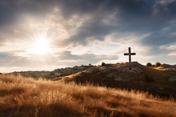 a cross on a hill with a sun in the background - obrazy, fototapety, plakaty