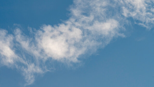 Sky with thin white clouds. Thin whiskey-colored clouds in a blue sky, a view of a sunny blue sky with thin white clouds, an image of a blue sky with thin white clouds