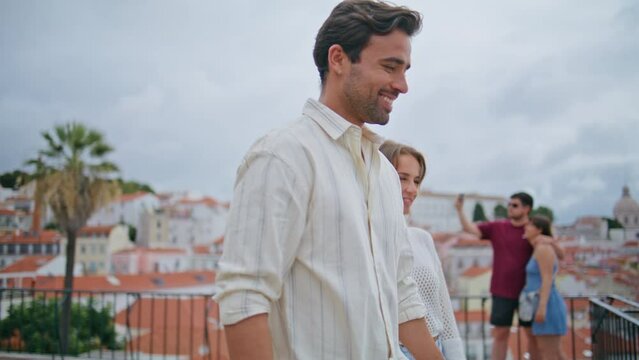 Romantic newlyweds walking terrace with cityscape closeup. Happy pair laughing