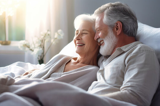 You are the beautiful part of my life. Happy elderly couple cuddling in bed. Romantic feelings. Love. - Powered by Adobe