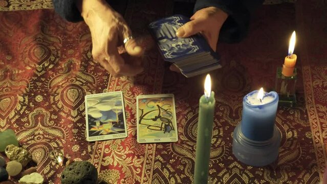 Close-up of a tarot spread with an unusual tarot deck to read the destiny in a mystical fortune-teller atmosphere.  Esoteric concept