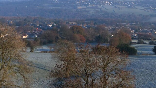 Rising Establishing Aerial Drone Shot Over Trees on Frosty Morning with Calverley Village in Background