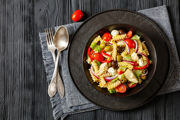 fusilli salad with mozzarella, veggies in a bowl