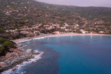 Fototapeta premium drone view of Cavoli Beach on Elba Island just after sunset with a misty purple sky