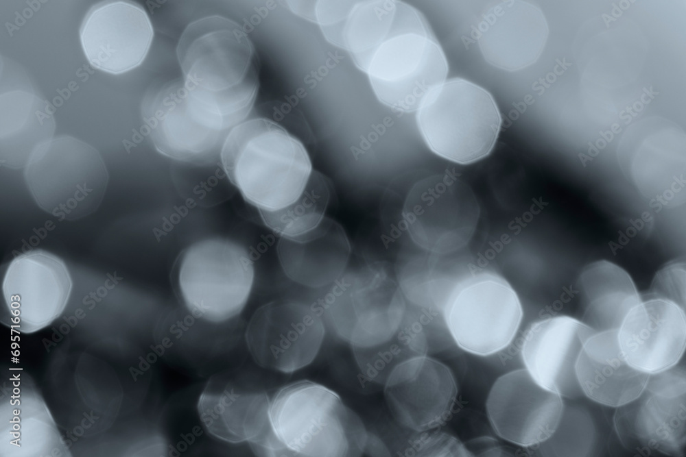 Poster defocused image of lights in black and white. layered gray bokeh spots. high resolution abstract bac